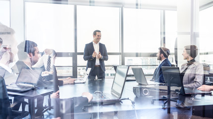 Successful team leader and business owner leading informal in-house business meeting. Businessman...
