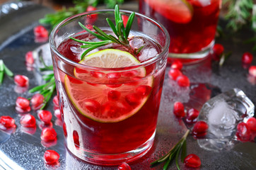 Pomegranate Cocktail Decorated with Lime, Rosemary and Ice, Cold Drink