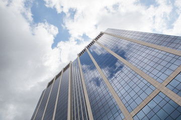 Fototapeta na wymiar clouds reflected in windows of modern office building
