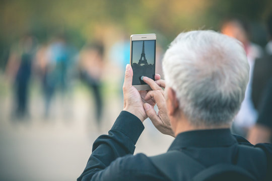 Man taking Smartphone Photo of Tour Eiffel - Paris