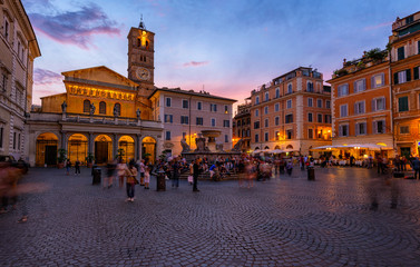 Basilica di Santa Maria in Trastevere and Piazza di Santa Maria in Trastevere at sunset, Rome, Italy. Trastevere is rione of Rome, on west bank of Tiber in Rome. Architecture and landmark of Rome.