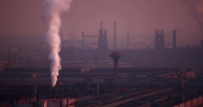view of the factory is shrouded in smog