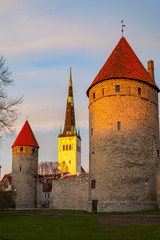 Fototapeta na wymiar Sunset over towers of Old Town and Oleviste church of Tallinn In Estonia. Spring time.