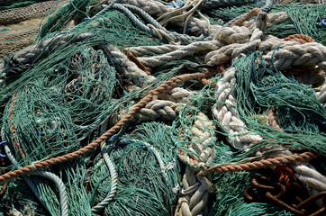 fishing nets deposited on the dock to dry