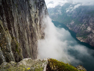 Cliff Edge view over Norwegian fjord with cloud inversion below -  Kjerag, Norway
