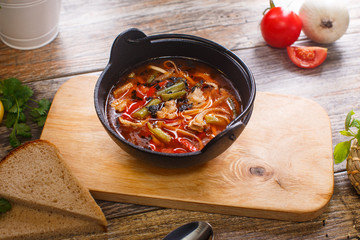 Hot goulash soup in a black pot
