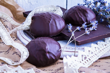 Chocolate bars, marshmallows in chocolate and dry lavender flowers on white wooden background