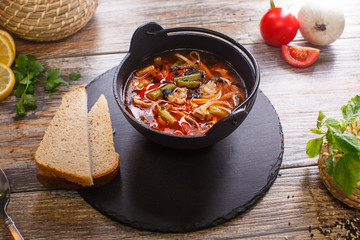 Hot goulash soup in a black pot