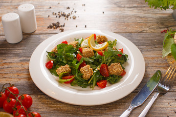 salad of arugula with cherry tomatoes and croutons