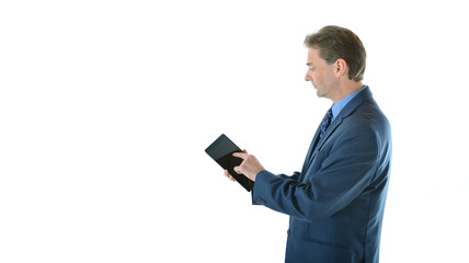 Business man standing and working on tablet (side view)