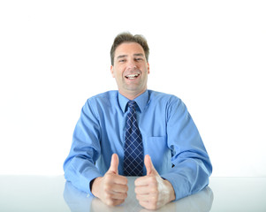 Business or sales man sitting at desk giving two big enthusiastic thumbs up