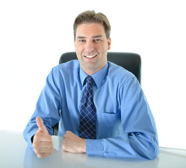 Business or sales man sitting at desk giving big enthusiastic thumbs up