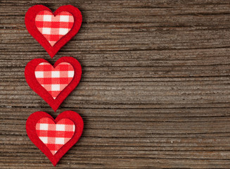 Red valentine's day hearts on vintage wooden vintage background a copy space. A symbol of love. Flat lay. Top view.