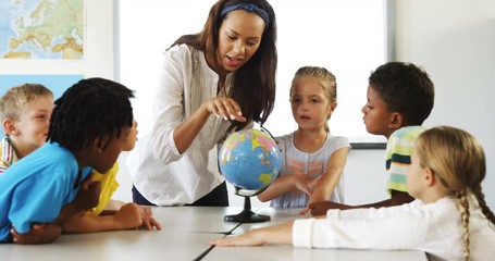 Happy school kids with globe in classroom - Powered by Adobe