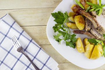 Roast pork with potato wedges and vegetables