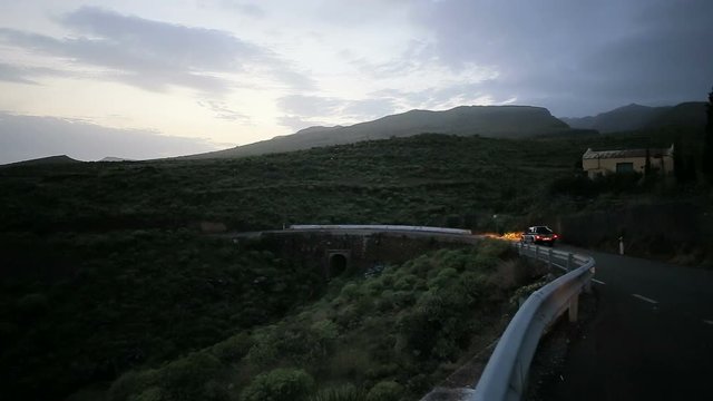 Car pssing by the mountain road