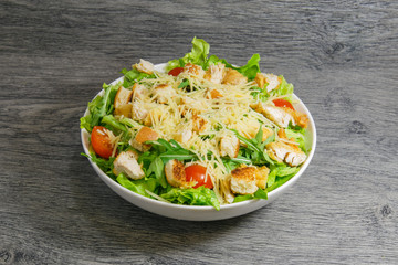 Caesar fresh salad with lettuce, tomatoes and parmesan cheese