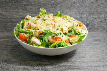 Caesar fresh salad with lettuce, tomatoes and parmesan cheese
