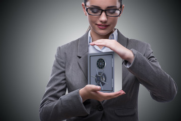 Businesswoman holding metal safe in security concept