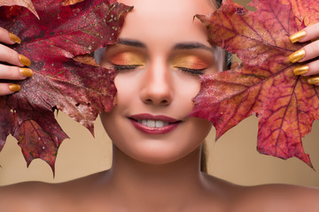 Beautiful woman in with autumn dry leaves