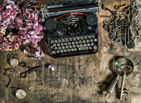 Vintage typewriter hortensia flowers old keys wooden table
