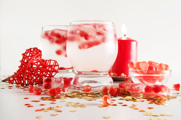 Romantic still life. Two glasses with alcoholic cocktail and ice, decorated with pomegranate, red...