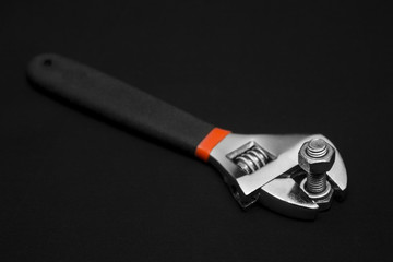 Hand tools, nuts and bolts, dark background