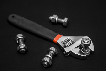 Hand tools, nuts and bolts, dark background