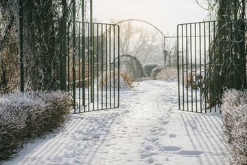 Entrance to the empty city park in winter