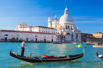 Fototapeta na wymiar Grand Canal with gondola against Basilica Santa Maria della Salute in Venice, Italy