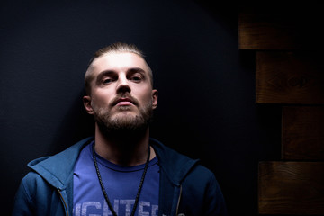 Portrait of a young handsome guy with a beard. In the Studio
