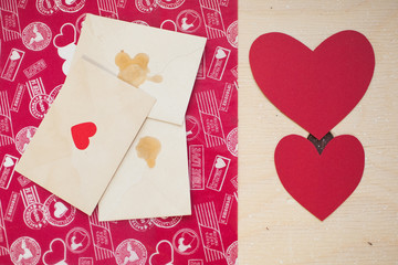 Few letters with red hearts on a wood table