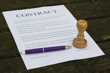 Pen and stamp on a filled contract