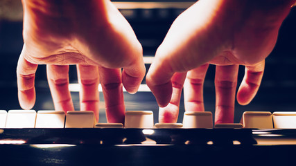 Close-up personal perspective of a woman's hands playing the piano