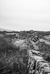 The wall in Peak District National Park in black and white. 