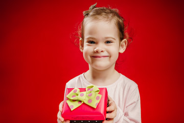 pretty and smiling girl holding a gift in their hands