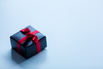 Little gift box on white glass background