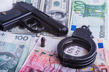 Handcuffs, money and gun.