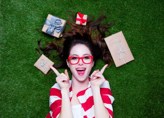 Portrait of a young redhead woman with present gifts