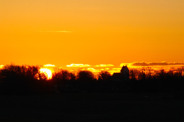 sunrise with a church in silhouette so beautiful in January
