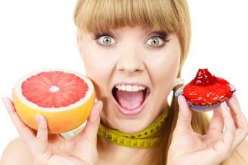 Woman choosing fruit or cake make dietary choice