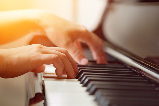 Woman's hands playing the piano