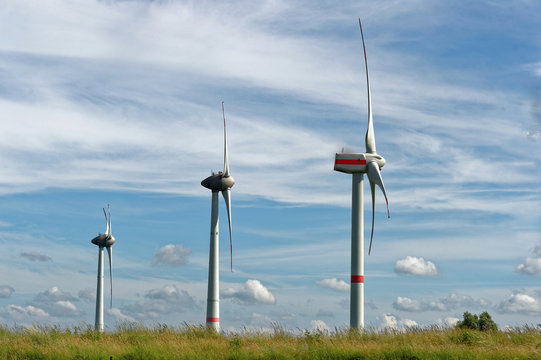 Three wind turbines in a row in rural landscape, Rysum, Lower Saxony, Germany