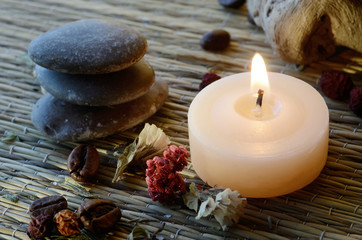Fototapeta na wymiar Spa still life - massage stones,candle, and body scrub components