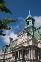 New French Imperialism architecture of City Hall in Old Montreal, Quebec, Canada.   Mansard roof and Neo-Classical details on a brigh blue day.