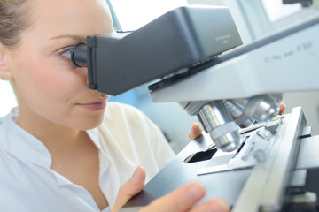 Woman using microscope
