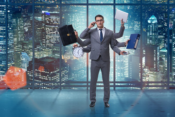 Young businessman in multitasking concept