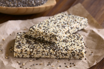 Chia sesame honey granola bars, photographed with natural light (Selective Focus, Focus on the front edge of the granola bars)