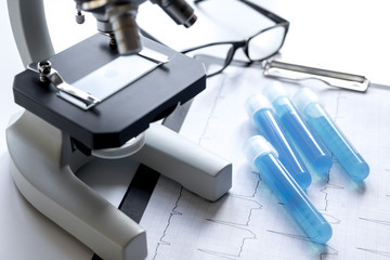 doctors desk with microscope and test tubes