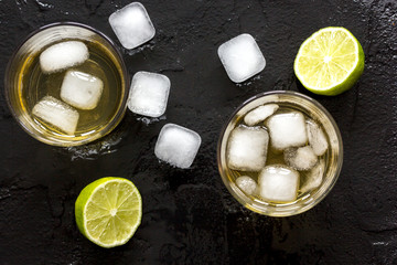 glass of scotch on dark background top view